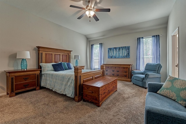 carpeted bedroom featuring ceiling fan, vaulted ceiling, and multiple windows