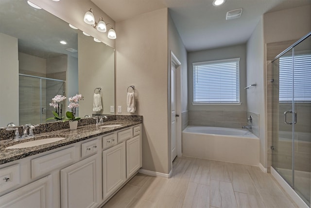 bathroom featuring plus walk in shower and vanity