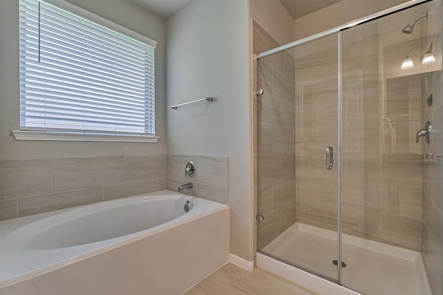 bathroom with tile patterned flooring and independent shower and bath