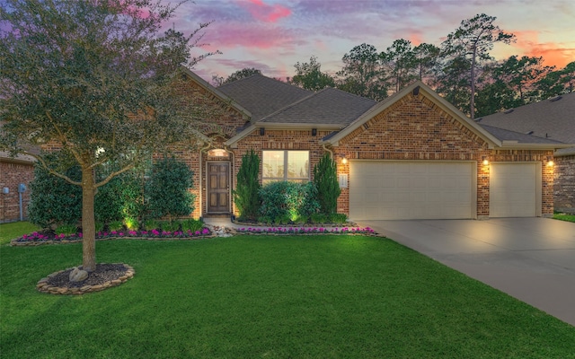 view of front of home featuring a yard and a garage