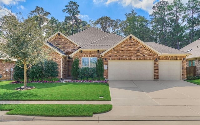 view of front of home with a garage and a front lawn