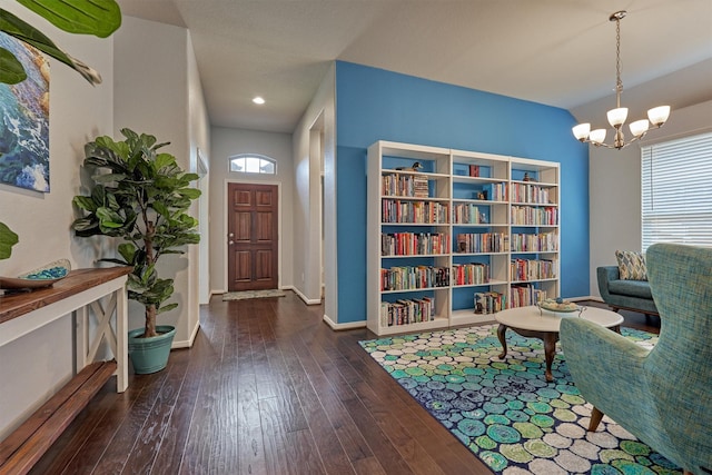 living area featuring an inviting chandelier and dark wood-type flooring