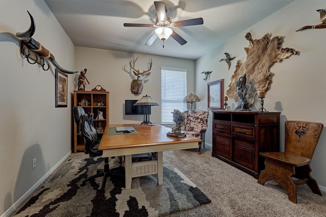 carpeted office featuring ceiling fan