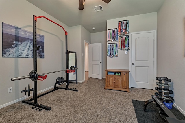 exercise room featuring ceiling fan and carpet