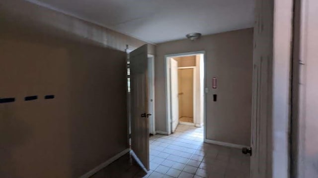 hallway featuring light tile patterned floors