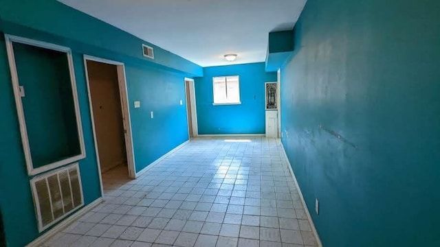 hallway featuring light tile patterned floors