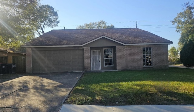 ranch-style house featuring a garage and a front lawn