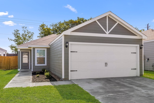 view of front of property featuring a front yard and a garage