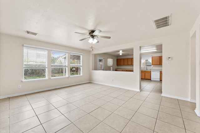 unfurnished living room featuring ceiling fan, light tile patterned floors, and sink