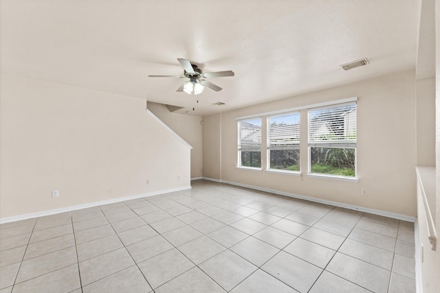 unfurnished room featuring ceiling fan and light tile patterned floors