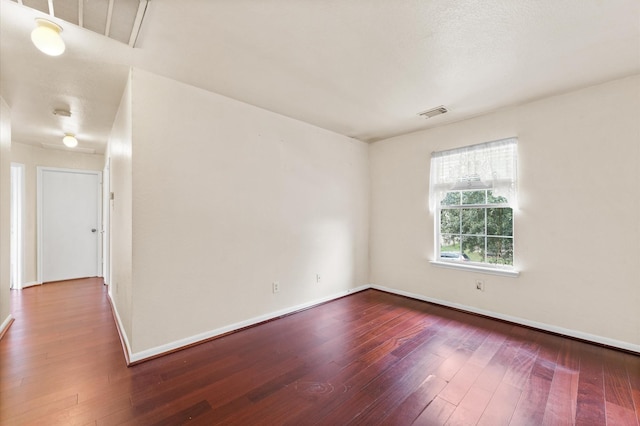 spare room with hardwood / wood-style flooring