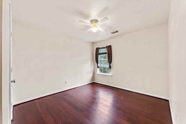 unfurnished room with ceiling fan and dark hardwood / wood-style flooring