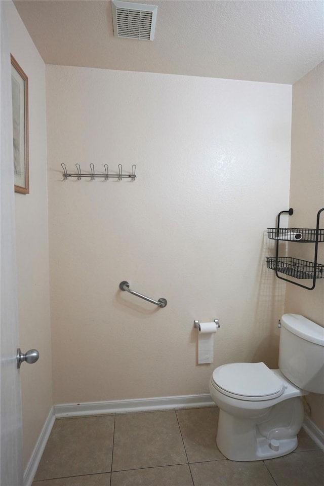 bathroom with tile patterned floors and toilet