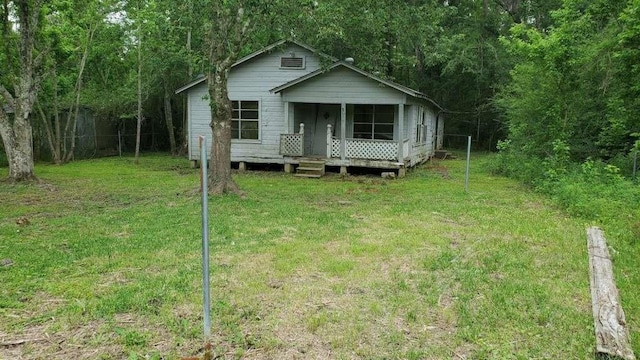 view of front of home with covered porch and a front yard