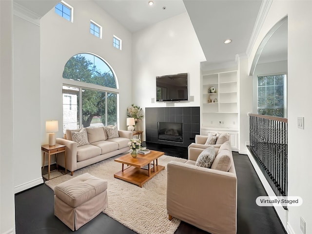 living room featuring crown molding, a fireplace, and hardwood / wood-style floors