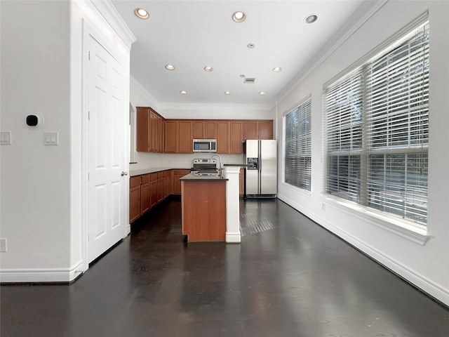 kitchen with ornamental molding, stainless steel appliances, and a kitchen island with sink