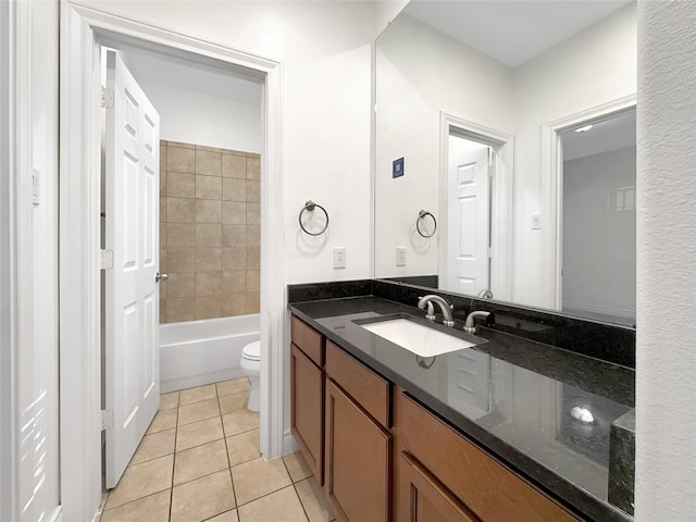 full bathroom featuring tile patterned floors, vanity, toilet, and tiled shower / bath