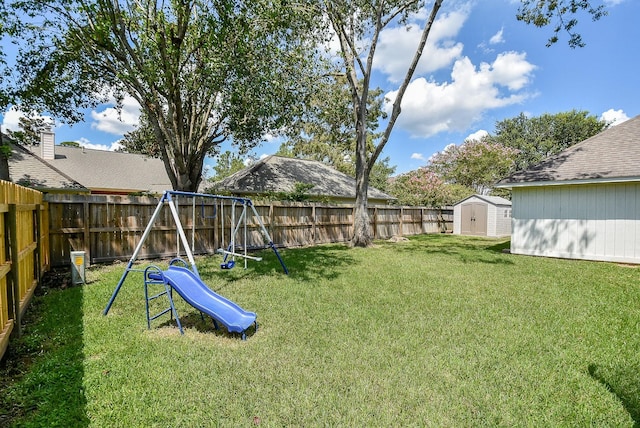 view of yard featuring a playground and a storage shed