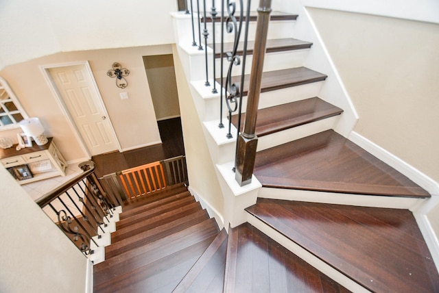 stairway featuring wood-type flooring