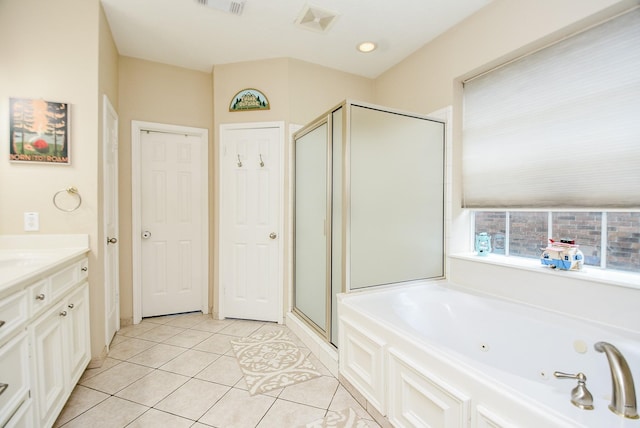 bathroom featuring tile patterned floors, vanity, and plus walk in shower