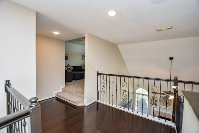 hallway featuring lofted ceiling and hardwood / wood-style flooring