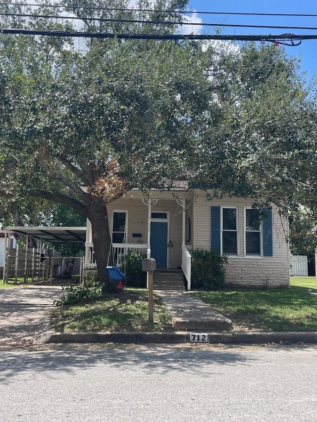 view of front of home with covered porch and a carport