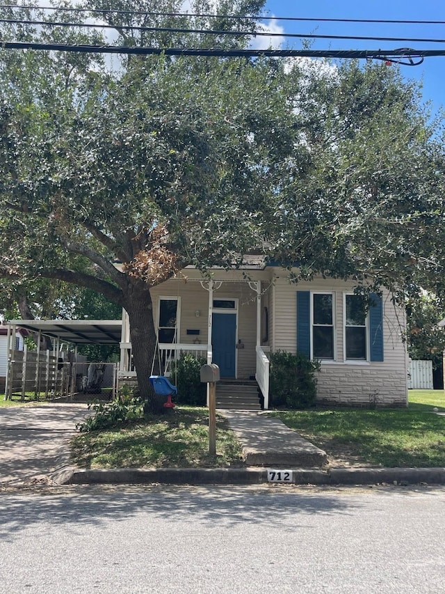 view of front of home featuring covered porch and a carport