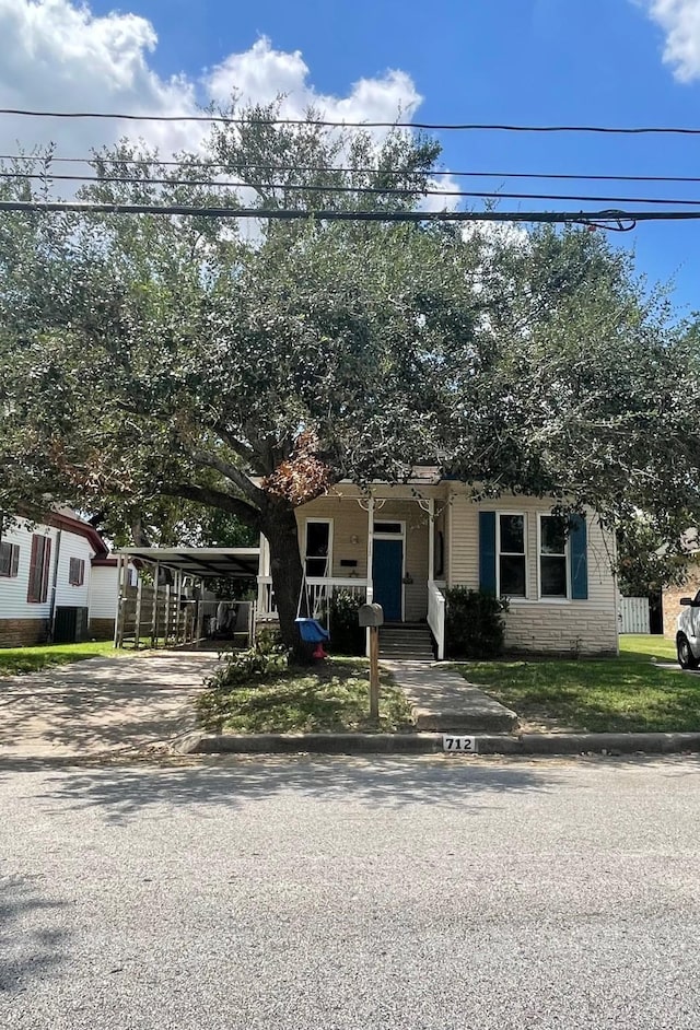 view of front of property featuring a carport and a porch