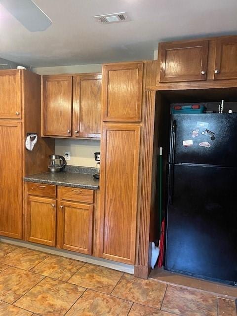 kitchen with black refrigerator and ceiling fan