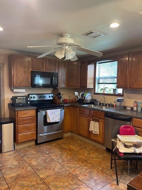 kitchen with appliances with stainless steel finishes, ceiling fan, and sink