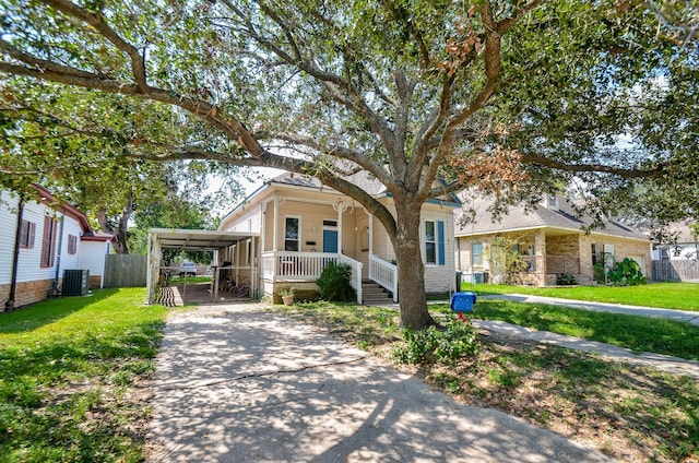 view of front of property featuring a carport, central AC unit, covered porch, and a front lawn