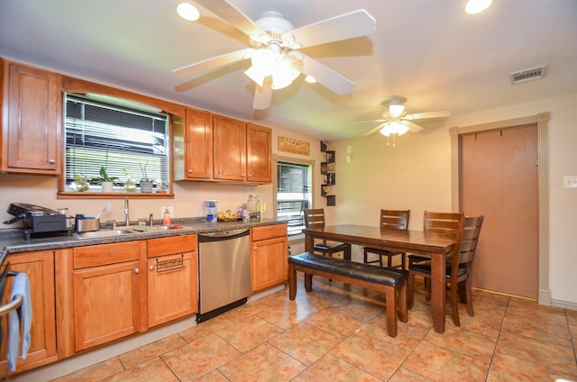 kitchen with stainless steel dishwasher, ceiling fan, light tile patterned floors, and sink