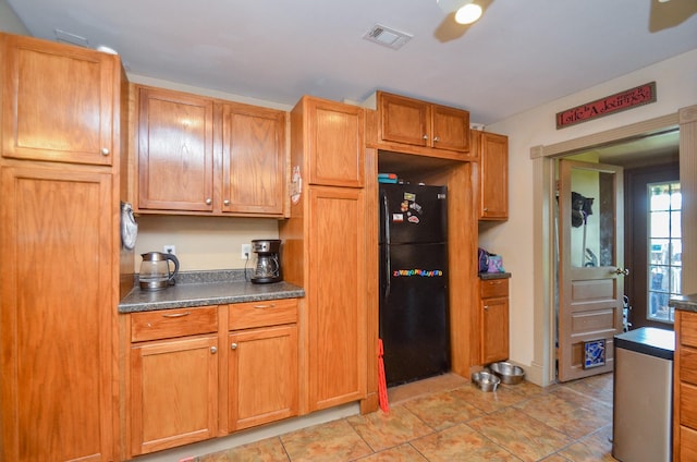 kitchen with ceiling fan and black fridge