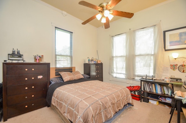 bedroom featuring ceiling fan, light colored carpet, and ornamental molding