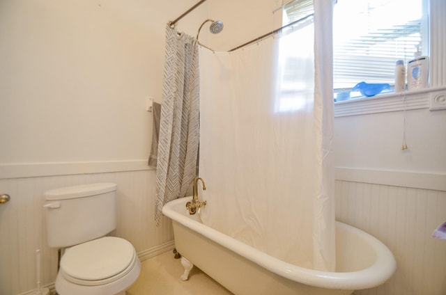 bathroom with shower / bath combination with curtain and toilet