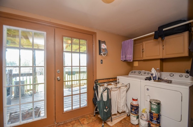 clothes washing area with cabinets, independent washer and dryer, and light tile patterned floors