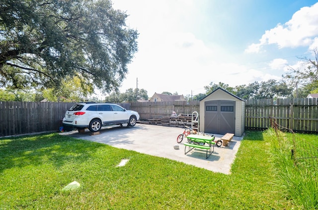 view of yard featuring a storage shed and a patio