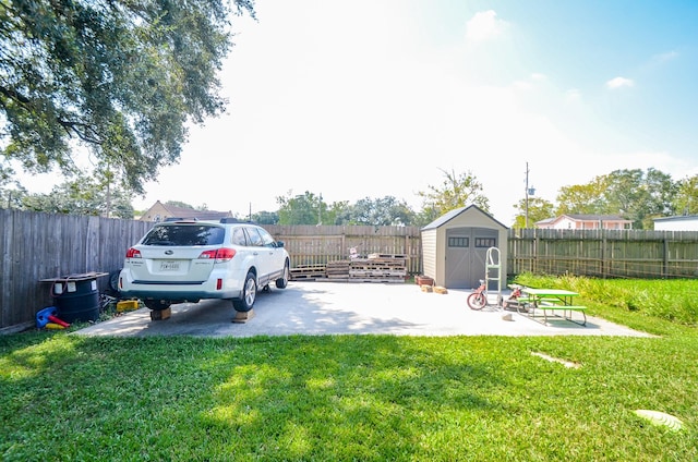 view of yard with a storage shed and a patio