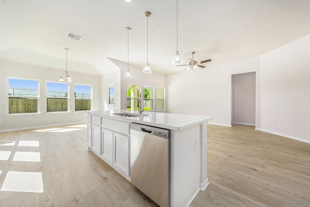 kitchen featuring ceiling fan with notable chandelier, a center island with sink, dishwasher, white cabinetry, and hanging light fixtures