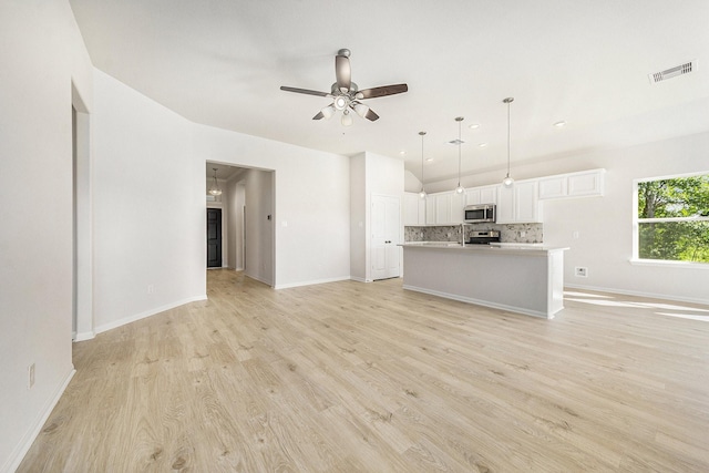 unfurnished living room with ceiling fan and light hardwood / wood-style floors