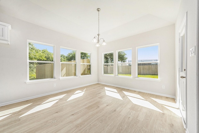 unfurnished sunroom featuring an inviting chandelier