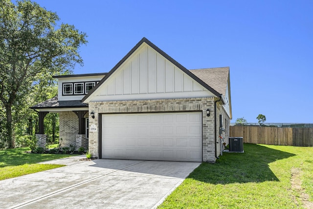 view of front of home with a front yard, a garage, and cooling unit