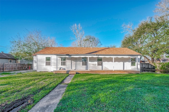 rear view of property with a yard