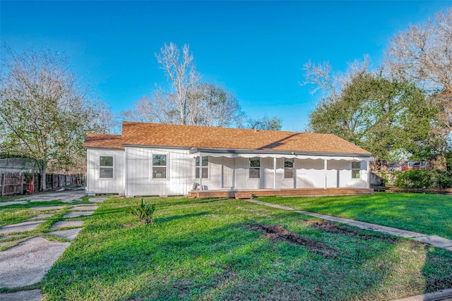 rear view of house with a lawn and covered porch