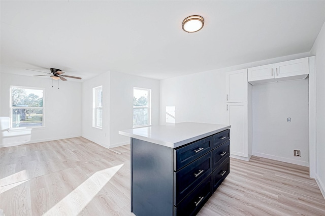 walk in closet featuring ceiling fan and light hardwood / wood-style flooring