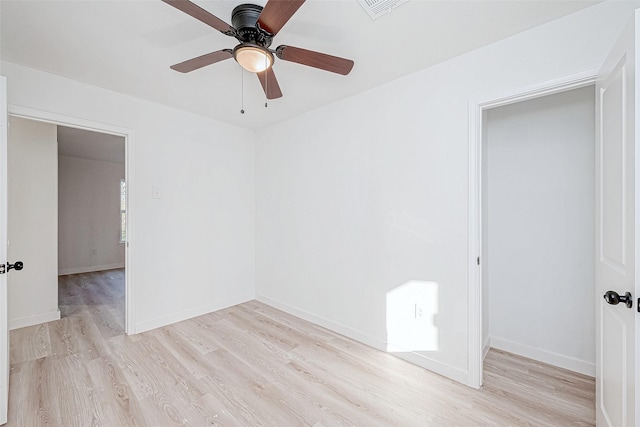 unfurnished room featuring light wood-type flooring and ceiling fan