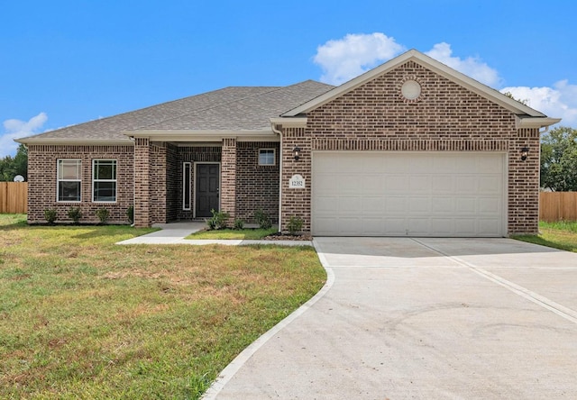 view of front of home with a garage and a front lawn