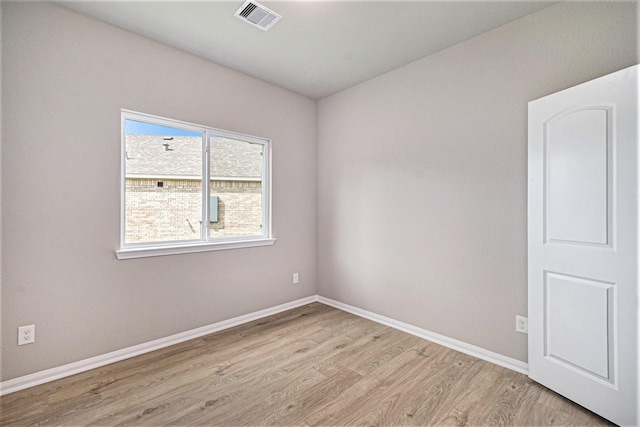 spare room featuring light hardwood / wood-style flooring