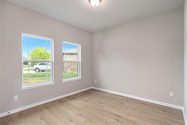 spare room with light hardwood / wood-style flooring