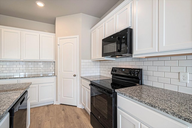 kitchen with decorative backsplash, light wood-type flooring, white cabinetry, and black appliances